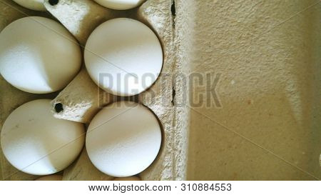 Top View Of White Whole Chicken Eggs In A Grey Natural Pappier Mashier Package With Copy Space
