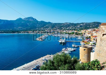 CALVI, FRANCE - SEPTEMBER 21, 2018: A view over the port of Calvi, in Corse, France, with many yachts moored in the piers of the marina, since the citadel, on top of a promontory