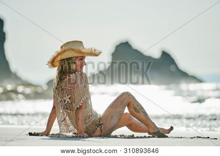young woman relaxing on the beach in summer day