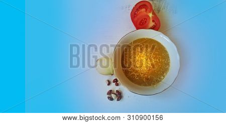 Vegetarian Lentils, Tomatos And Pumpkin Cream Soup In White Deep Bowl With Seeds On Light Blue Backg