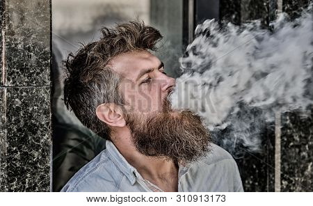 Smoking Electronic Cigarette. Stress Relief Concept. Smoking Device. Man Long Beard Relaxed With Smo