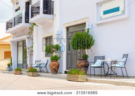 Empty Chairs With Table Near The Building. Cafe Exterior Background. Tourism Concept. Traveling Conc