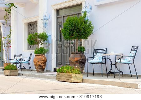 Empty Chairs With Table Near The Building. Cafe Exterior Background. Tourism Concept. Traveling Conc