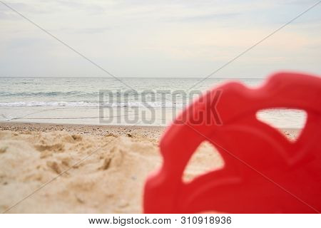 Frisbee In Sand On The Beach. Selective Focus