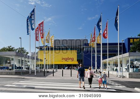 Huddinge, Sweden - July 11, 2019: A Family Walking Towards The Ikea Store Entrance At Kungens Kurva 
