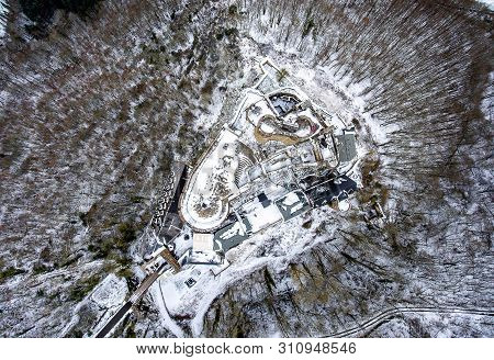 Aerial View Rock With Medieval Castle On It Near Moselle River In Brodenbach Winter With Forest Snow