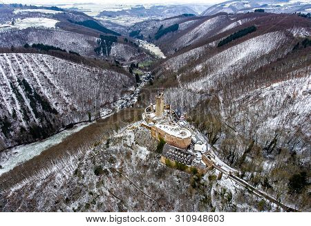 Aerial View Rock With Medieval Castle On It Near Moselle River In Brodenbach Winter With Forest Snow