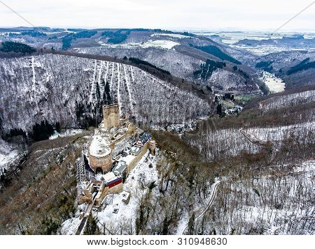 Aerial View Rock With Medieval Castle On It Near Moselle River In Brodenbach Winter With Forest Snow