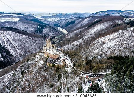 Aerial View Rock With Medieval Castle On It Near Moselle River In Brodenbach Winter With Forest Snow