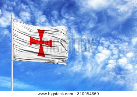 National Flag Of Templiers On A Flagpole In Front Of Blue Sky