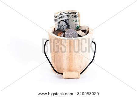 Wooden Bucket And Money, Us Dollars Bank Notes, Penny, Nickel, Dime, Quarter On A White Background. 