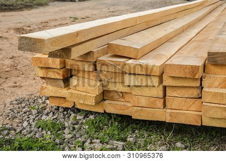Stacked Lumber. Folded Wood.closeup Wooden Boards.the Surface Of The End Of The Board.lots Of Planks