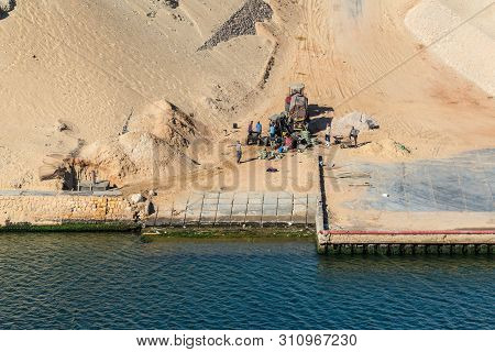 Ismailia, Egypt - November 5, 2017: A Team Of Builders On The Shore Of Suez Canal Near Ismailia, Egy