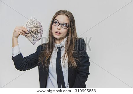 Satisfied, Excited Young Business Woman Is Showing A Pile Of Money, Isolated On White Background. Gi