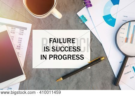 Failure Is Success In Progress Is Written In A Document On The Office Desk With Office Accessories, 