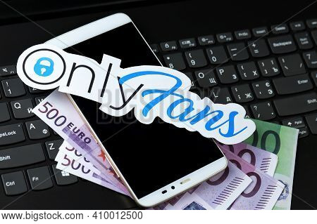 Kharkov, Ukraine - February 14, 2021: Onlyfans Paper Logo With Smartphone And Euro Bills On Black La