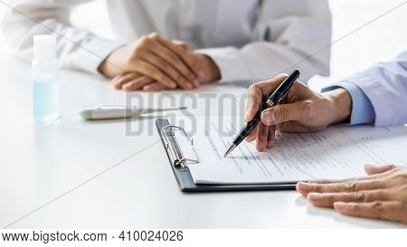 Asian Woman Filling A Coronavirus Self Reporting Form With A Doctor Recommended At Hospital. Medical