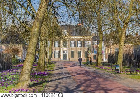 Assen, Netherlands - February 25, 2021: Street With Trees And Crocuses Leading To The Drents Museum 