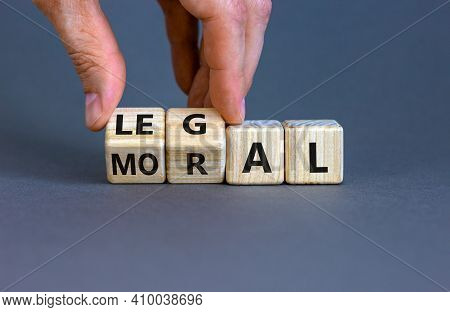 Moral Or Legal Symbol. Businessman Hand Turns Wooden Cubes And Changes The Word 'moral' To 'legal' O