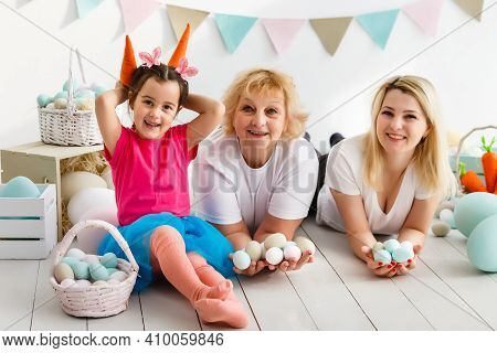 Happy Family With Easter Eggs. Happy Llittle Girl And Grandmother With Easter Eggs