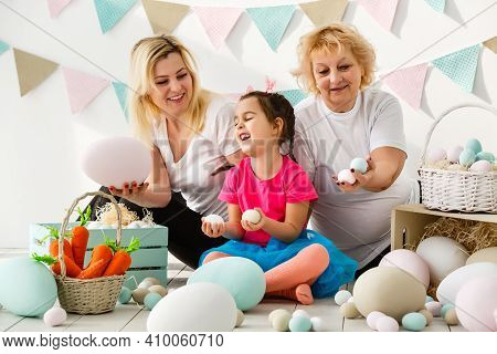 Happy Family With Easter Eggs. Happy Llittle Girl And Grandmother With Easter Eggs