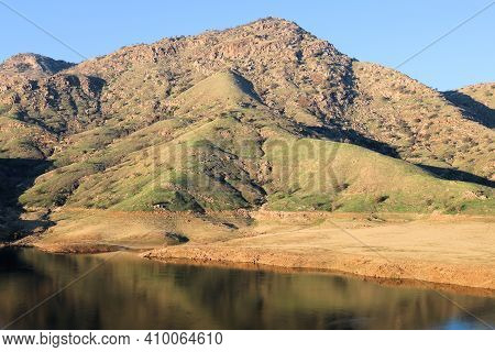 Lake Surrounding Barren Hills Covered With Grasslands Taken At Lake Kaweah, Ca In The Foothills Of T