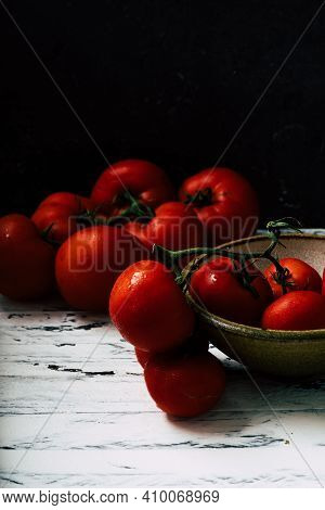 Fresh Oraganic Tomatoes On A Branch