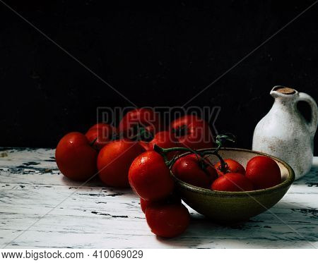 Fresh Oraganic Tomatoes On A Branch