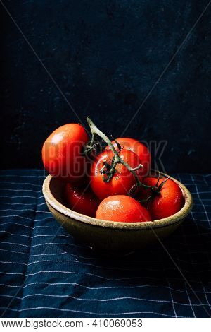 Fresh Oraganic Tomatoes On A Branch