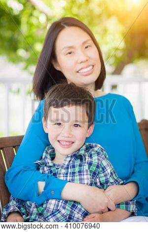 Outdoor Portrait of Chinese Mother with Her Mixed Race Chinese and Caucasian Young Boy.