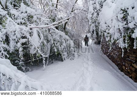 Streets And Buildings Covered In Snow By Day Due To Snowstorm Filomena Falling In Madrid Spain. Peop