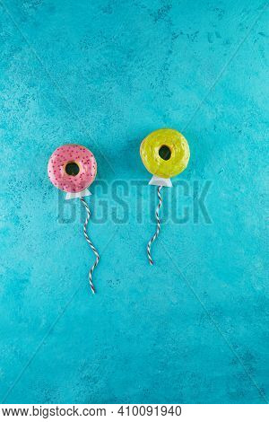 Multicolored Donuts With Glaze And Sprinkles In The Form Of Balloons Flying In The Sky