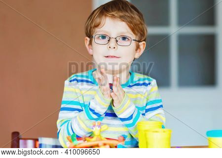 Smiling Preschool Kid Boy Having Fun With Dough, Colorful Modeling Compound Clay. Creative Leisure W