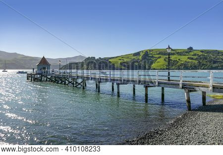 Idyllic Landscape With Wooden Pier Around Akaroa, A Small Town In The Canterbury Region Of The South