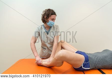 Physiotherapist And Patient In Global Postural Re-education Session, With Pandemic Protection Mask.