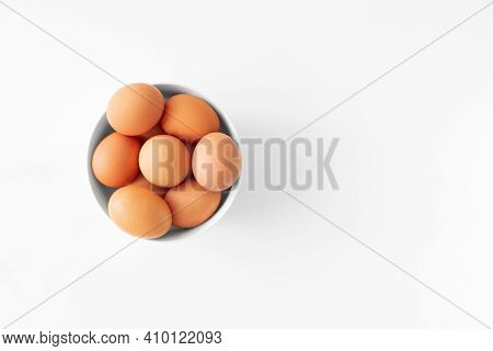 Brown Eggs In Bowl Flat Lay On White Background Top View Copy Space. Minimalism Style Easter Day. Ch