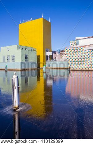 Groningen, Netherlands - February 13, 2021: Yellow Tower Of The Museum Reflected In The  Frozen Cana