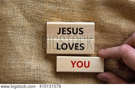 Jesus Loves You Symbol. Concept Words 'jesus Loves You' On Wooden Blocks On A Beautiful Canvas Backg