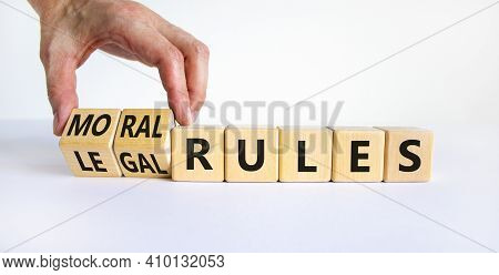 Legal Or Moral Rules Symbol. Businessman Turns Wooden Cubes And Changes Words Legal Rules To Moral R