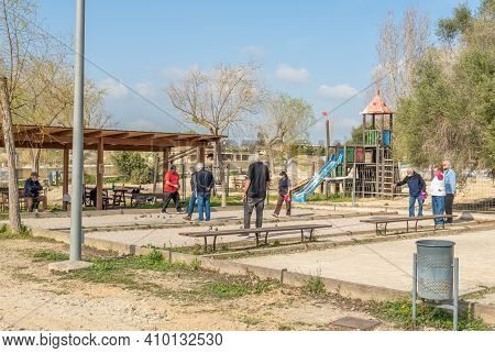 Vilafranca De Bonany, Spain; February 27 2021: Group Of Elderly People Playing A Game Of Petanque In