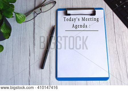 Today's Meeting Agenda Text On Blue Clip Board. Meeting Goals Concept