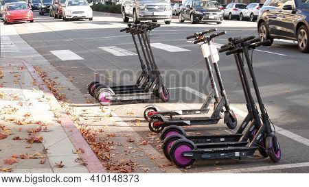 San Diego, California Usa - 4 Jan 2020: Row Of Ride Sharing Electric Scooters Parked On Street In Ga