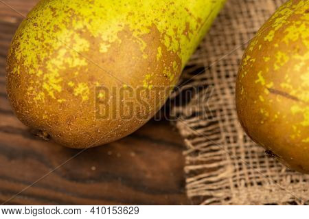Ripe Juicy Pears Are Made On A Homespun Fabric With A Rough Texture. Close-up, Selective Focus.