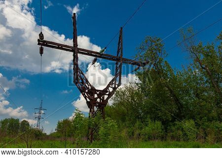 Old Metal Power Line Tower On Cloudy Sky Background