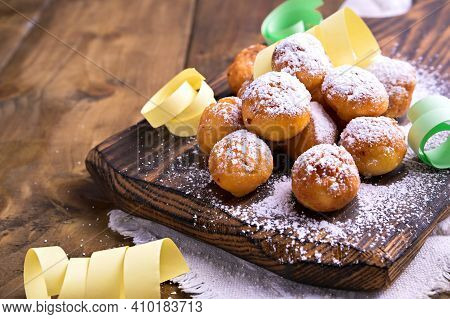 Baked Castagnole With Powdered Sugar . Street Food, Round Biscuits With Sugar For The Carnival Of Ve