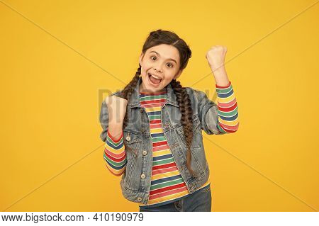 Always A Winner. Happy Little Winner Yellow Background. Small Girl Make Winner Gesture. Celebrating 