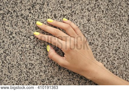 Professional Nail Care. Female Hand With Yellow Nail Color. Applying Nail Lacquer. Nail Salon Manicu