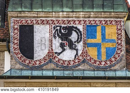 Chur, Switzerland - February 19, 2021: Flags And Coat Of Arms Of The Medieval Town Of Chur And The S