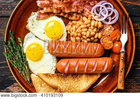 Traditional Full English Breakfastt With Fried Eggs, Sausages, Bacon, Beans And Toasts. Dark Wooden 