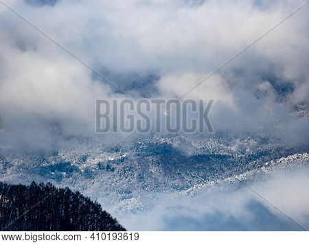 Clouds And Mist Rise Above The Forests In The Foothills Of The Japanese Alps In Nagano Prefecture, J